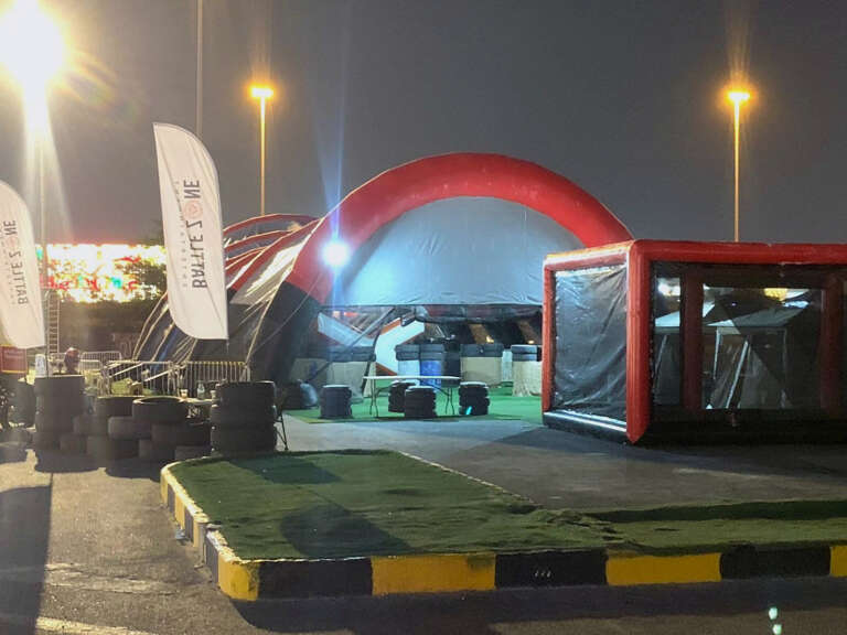 Entrance to the inflatable paintball arena at night