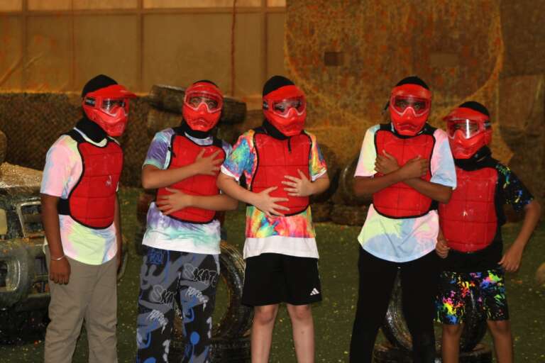 Birthday guests lined up in masks and vests
