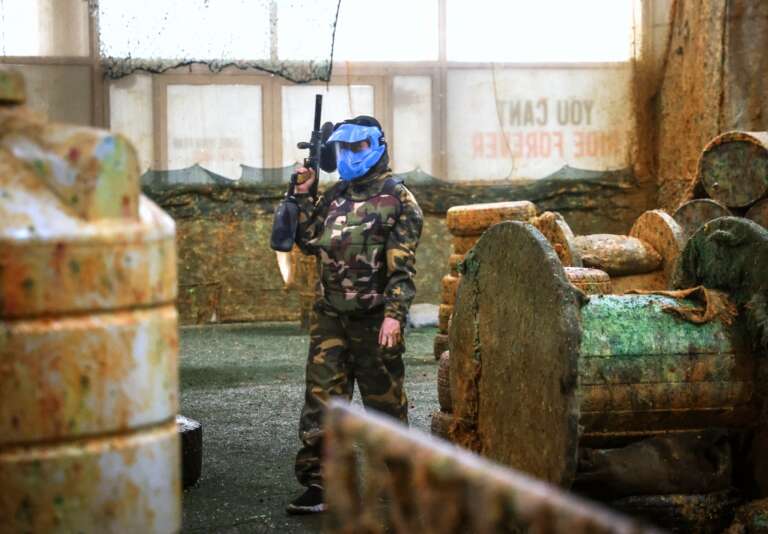 Player in camo and blue mask on the field
