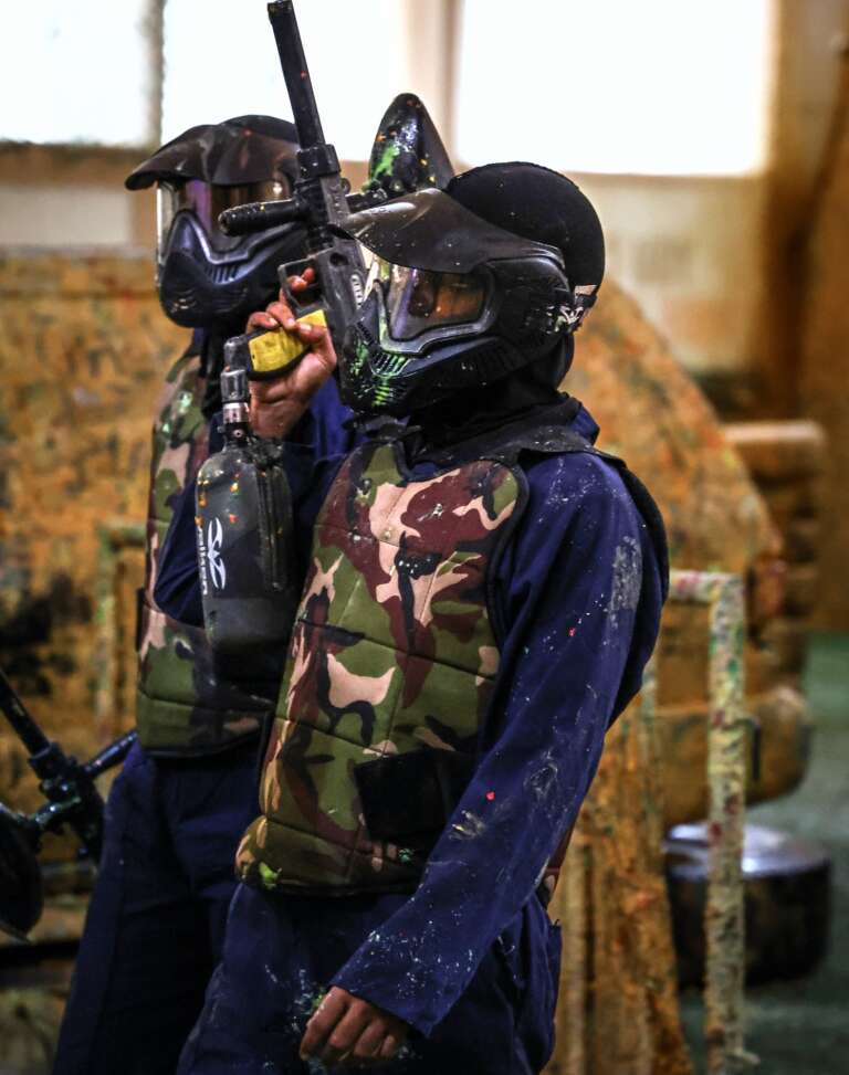 Two teammates in masks and camo