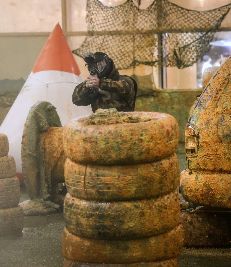 Player aiming from behind a tyre tower