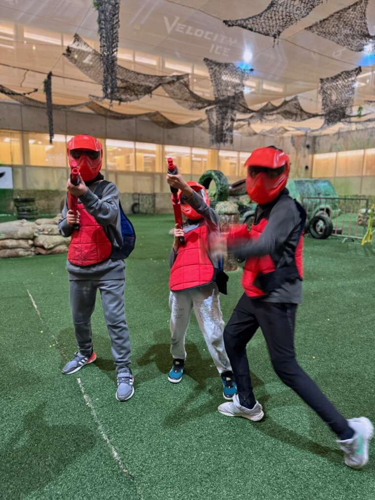 Red team juniors in masks ready to play