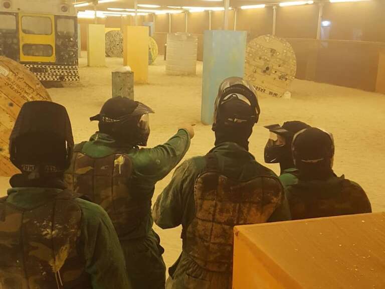 Masked players getting a briefing at the Al Wakrah Beach event