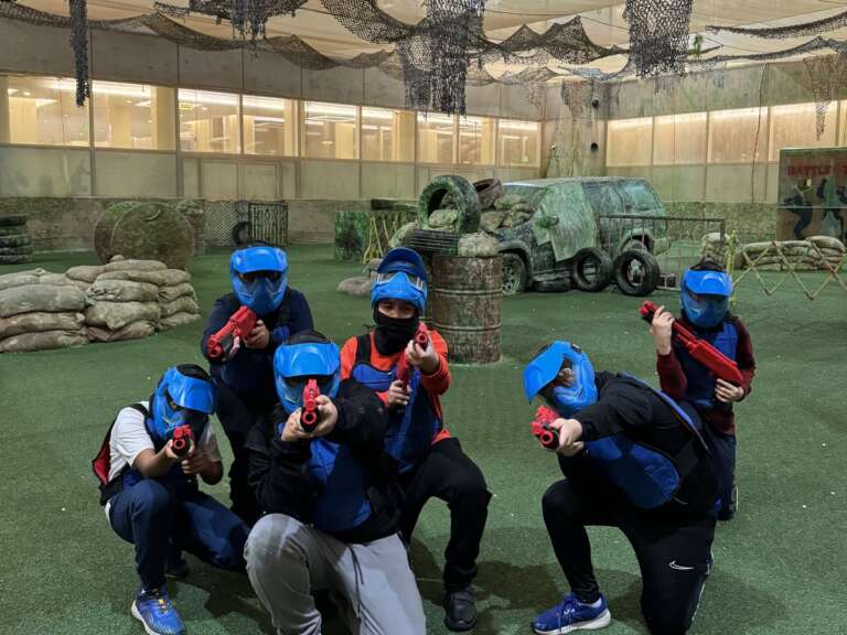 Junior team in masks playing together with kids’ markers