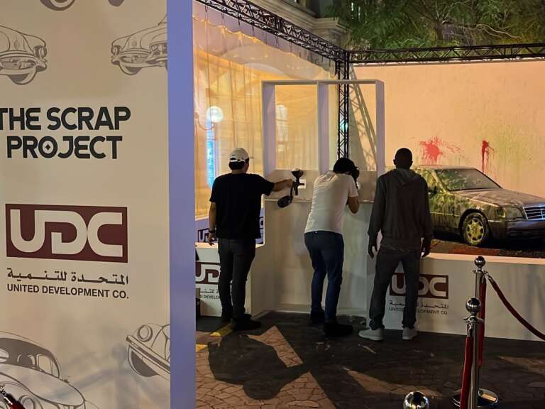 Guests shooting paint at the car wall at The Pearl event
