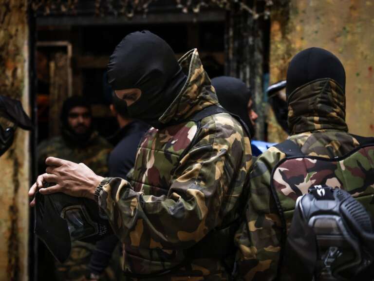 Adult players pulling on balaclavas and gear before the game