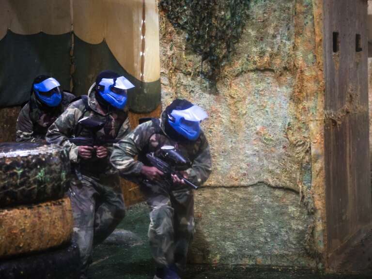 Corporate team advancing together behind cover