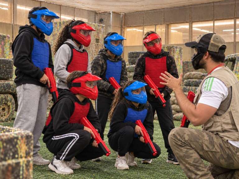 Junior players in masks listening to the safety briefing